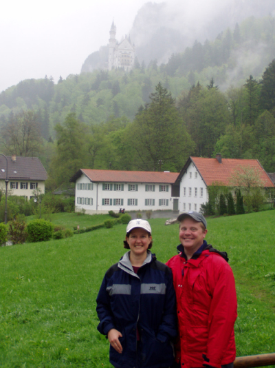 Susie and her husband Jonah in Bavaria 2004. Castle Neuschwanstein is in the distant mist.